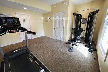 A home gym with a treadmill and exercise equipment